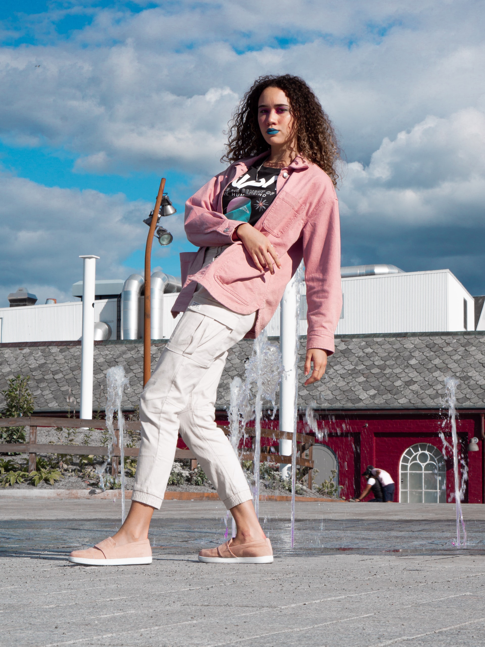 Girl in pink top and white cargo pants