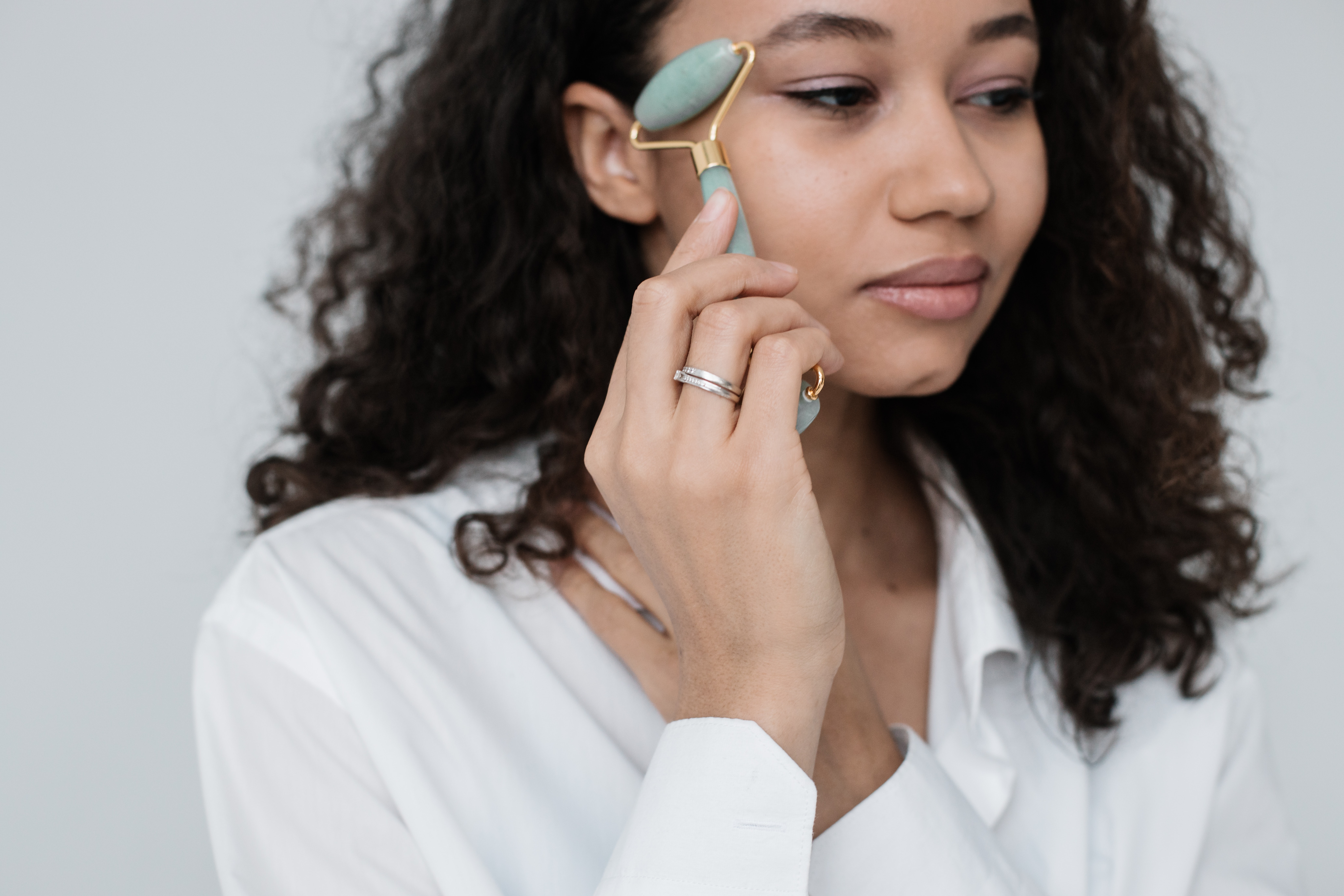 Woman using a roller on her face
