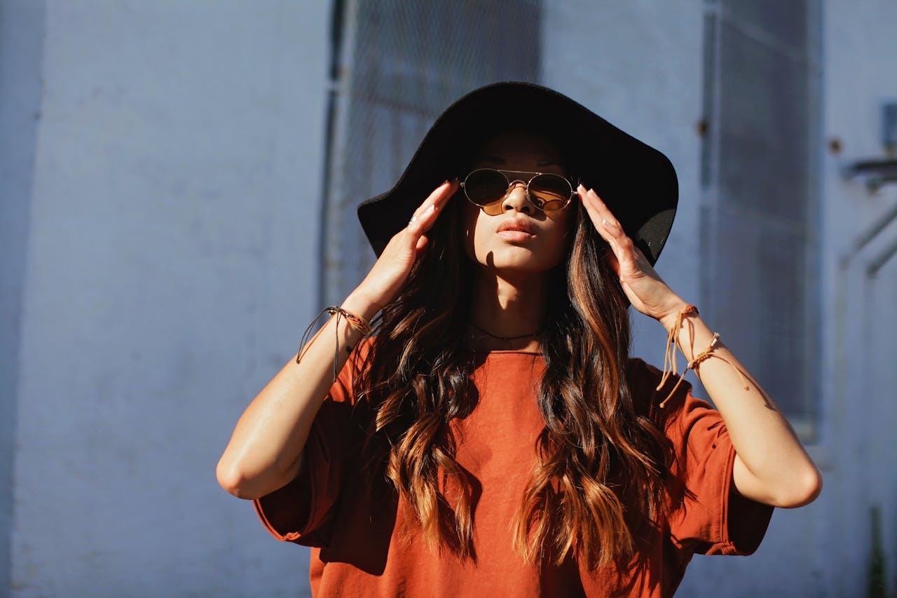 Woman in a hat standing in the sunshine
