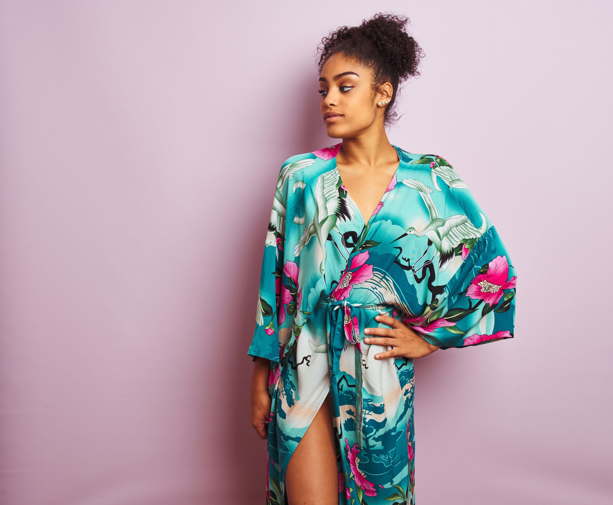Young beautiful african american woman standing wearing elegant colorful caftan